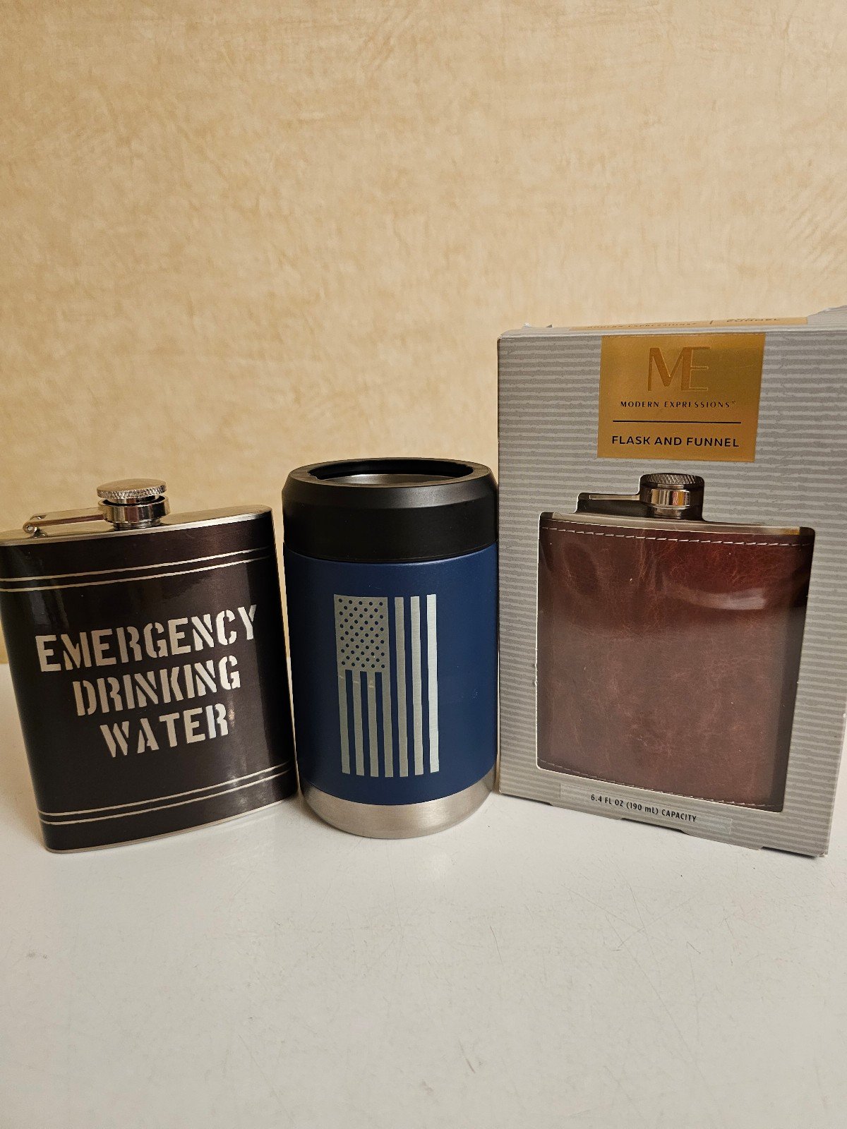 Brown leather flask, black metal flask, and American fl